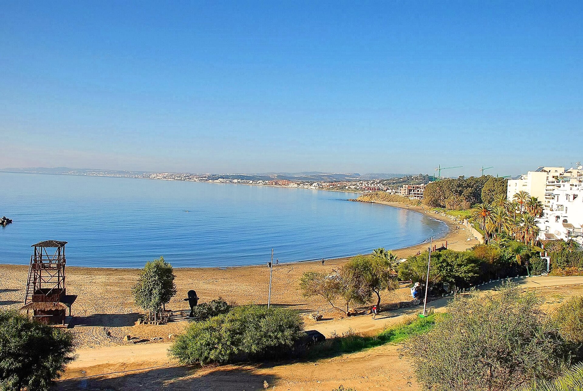 The sheltered curve of El Cristo Beach beside Estepona marina